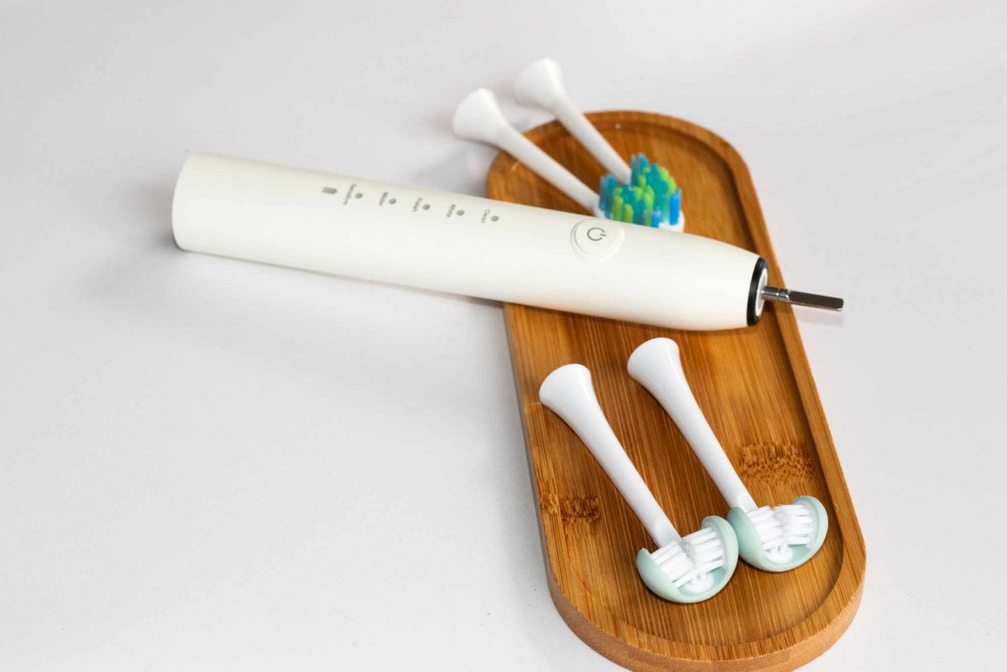 Adult electric toothbrush by Trio Teeth NZ with sleek design and rotating brush head for effective dental cleaning.