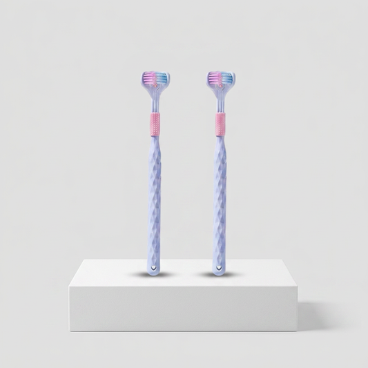 Pair of adult toothbrushes from Trio Teeth NZ with ergonomic handles and soft bristles for effective oral cleaning.